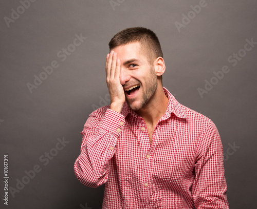 Man covering eyes his face