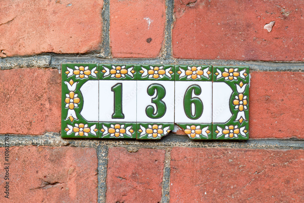 House number 136 sign on painted tiles House number 136 sign on painted tiles
