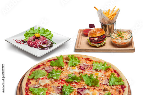 fast food and unhealthy eating concept - close up of hamburger or cheeseburger, deep-fried french fries, pizza and ketchup on wooden table top view