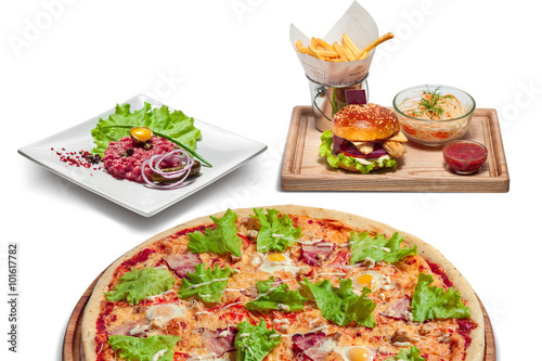 fast food and unhealthy eating concept - close up of hamburger or cheeseburger, deep-fried french fries, pizza and ketchup on wooden table top view