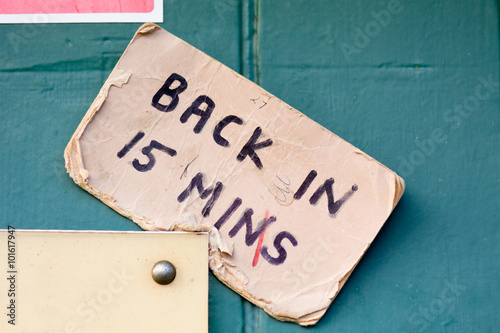 Back in 15 minutes sign on doorway of business
