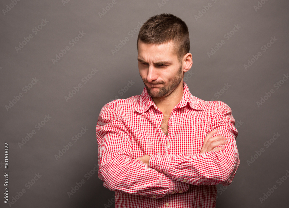 Man posing with crossed arms in studio Man posing with crossed arms in studio