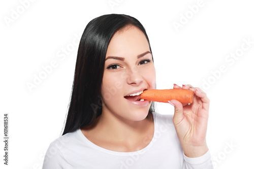 woman eating a carrot