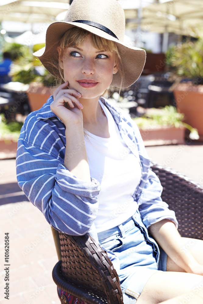 Blue eyed woman in hat looking away