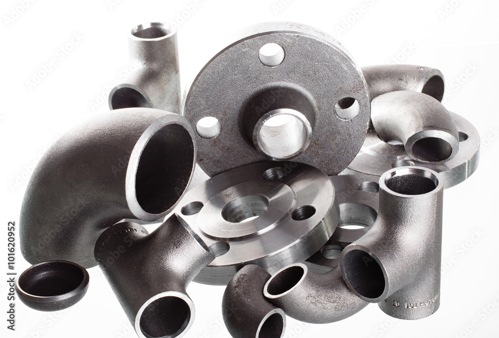Steel welding fittings on group. Flanges, elbow, tees and plug on white space.