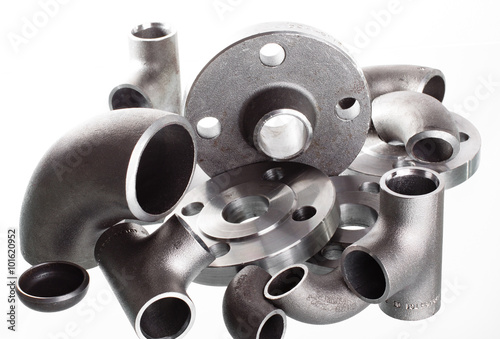 Obraz na płótnie Steel welding fittings on group. Flanges, elbow, tees and plug on white space. w salonie