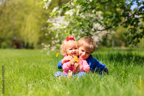 happy kids play with spring flowers 