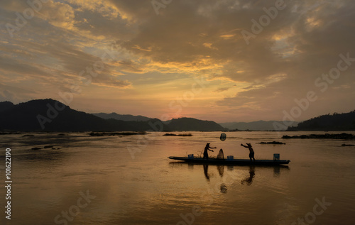 Two fishermen fishing, Mekong river, Sangkhom, Thailand photo