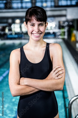 Smiling swimmer woman with arms crossed