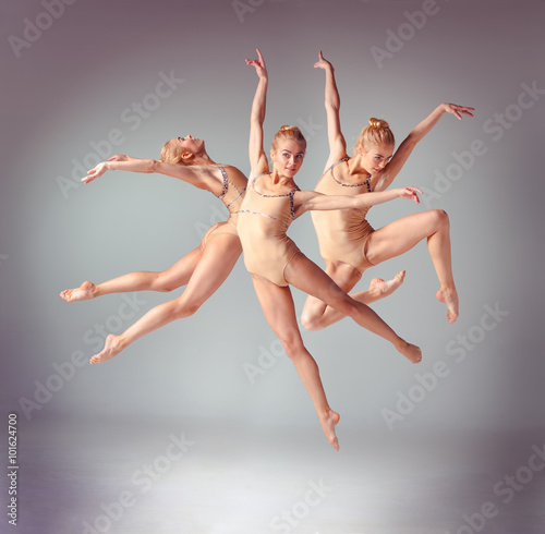 Fototapeta Naklejka Na Ścianę i Meble -  The young beautiful ballerina dancer jumping on a gray background. Collage