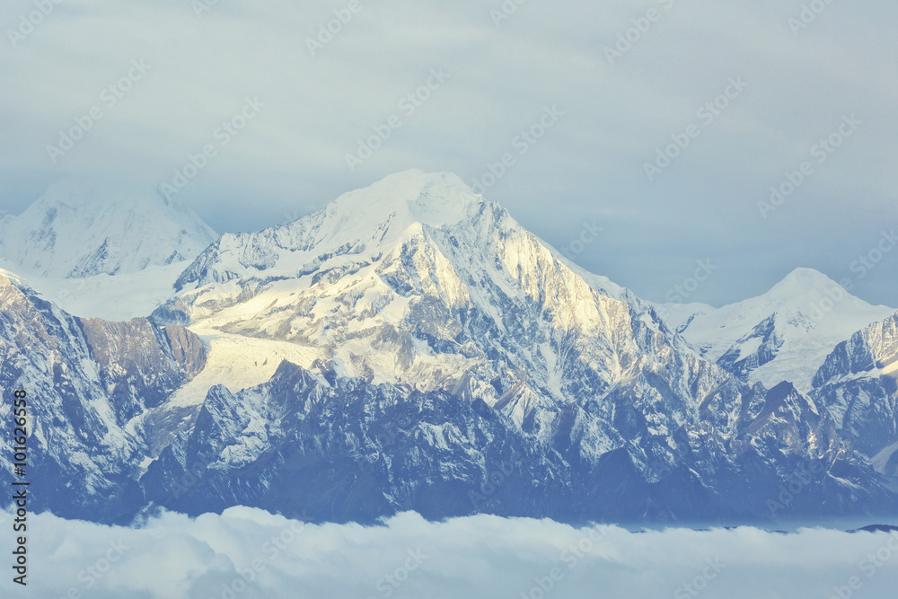 beautiful rolling clouds and frozen mountain summits landscape