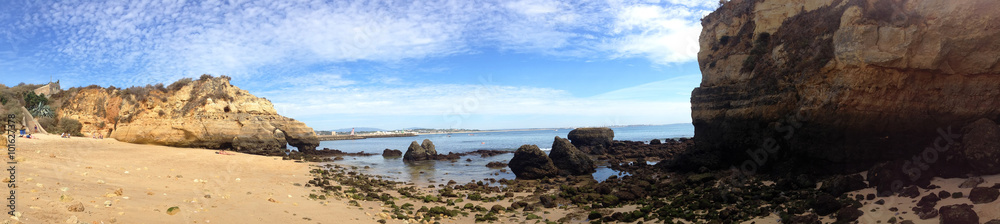 background panoramic view of the amazing sandy beach with golden cliffs in Lagos, Portugal