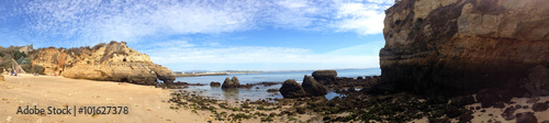 background panoramic view of the amazing sandy beach with golden cliffs in Lagos, Portugal