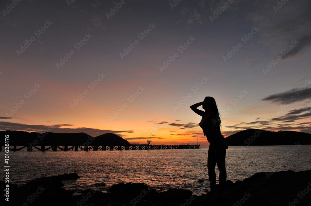Fototapeta premium woman on beach in twilight