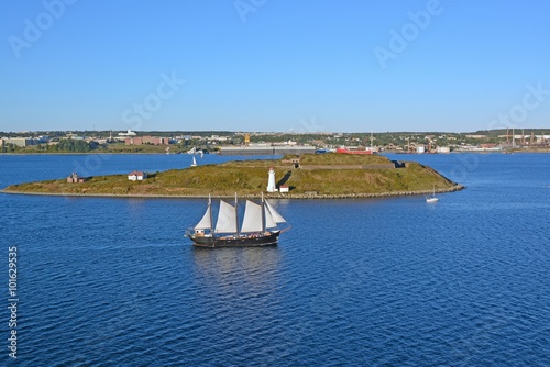 large sail boat passing in front of Georges Island in the Halifax Harbour, Dartmouth, Nova Scotia in the background