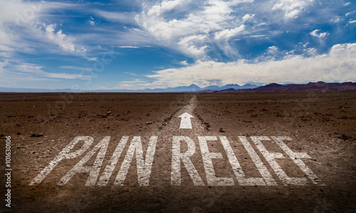 Pain Relief written on desert road