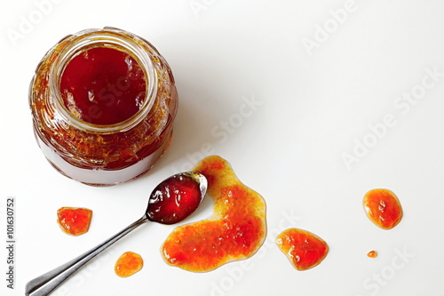 Jam made from the orange berries of sea buckthorn on a white background. Photo from above.