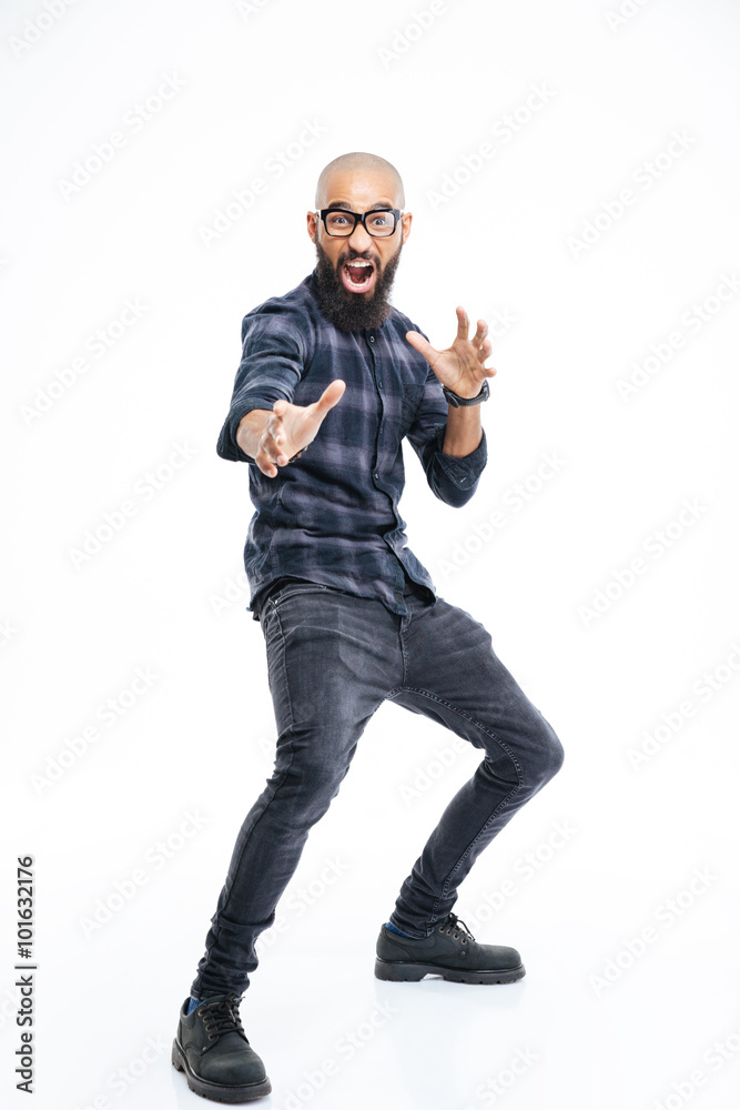 Funny baldheaded young african american man showing karate kick Funny baldheaded young african american man showing karate kick