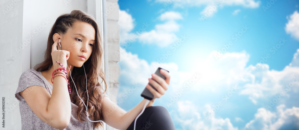 Fototapeta premium teenage girl with smartphone and earphones