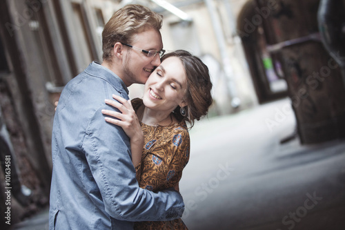 Young couple in love outdoor.  Man hugs  woman. kiss on the forehead © Ulia Koltyrina