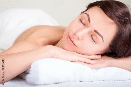Closeup portrait of attractive woman enjoying day spa in luxury beauty salon