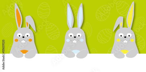 Easter banner with cute cartoon easter bunnies and easter eggs on green background