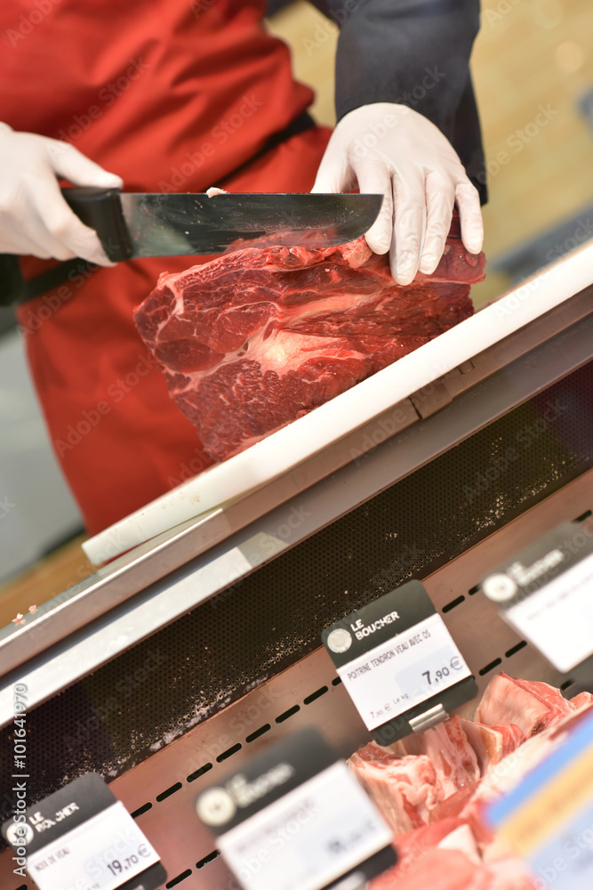 Butcher serving meat in supermarket