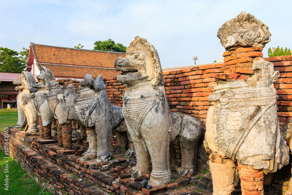 Fototapeta premium Antique Stupa surrounded by Lion statue cambodia style in Thammikarat Temple in Ayutthaya, Thailand