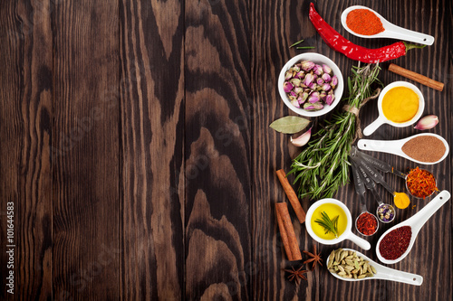 Herbs and spices over wood background