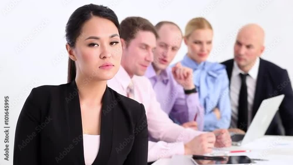 Successful business team/Businesswoman welcoming smiles on the background of his team Successful business team/Businesswoman welcoming smiles on the background of his team