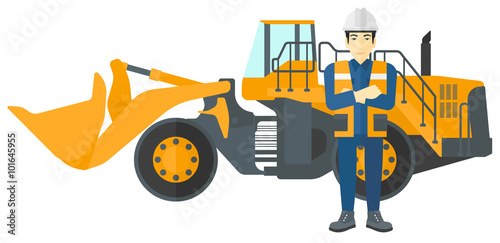 Miner with mining equipment on background.