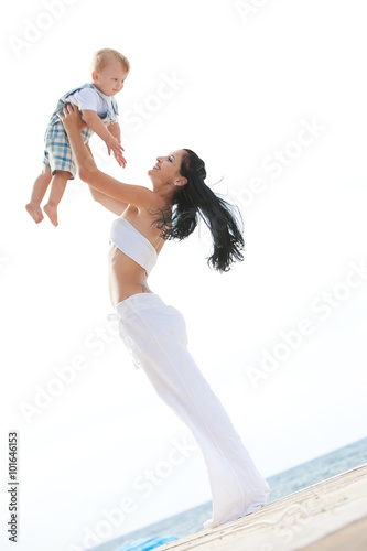 happy mother with son on the beach 
