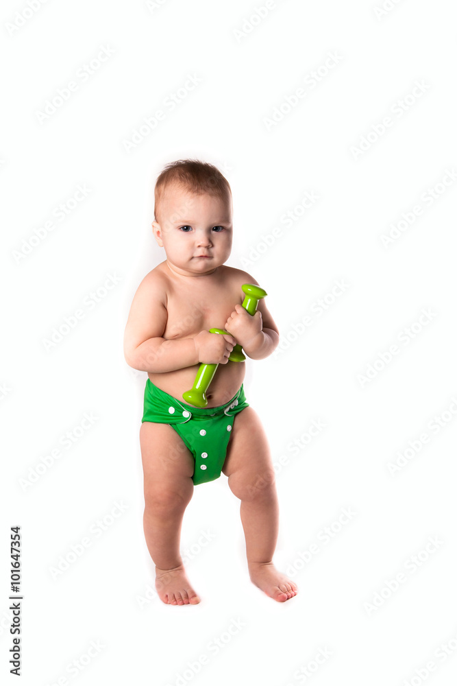 baby kid, toddler in green diapers doing exercises with dumbbel baby kid, toddler in green diapers doing exercises with dumbbel