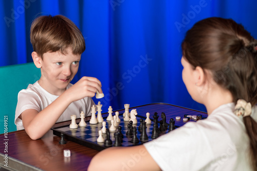 Children play a board game called chess.