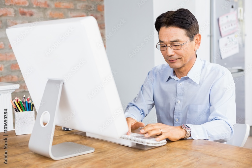 Smiling man using computer Smiling man using computer