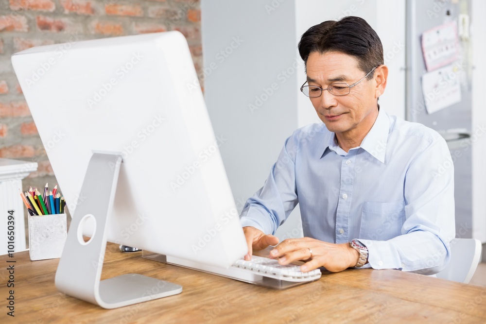 Smiling man using computer