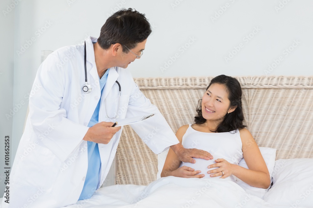 Fototapeta premium Doctor visiting pregnant woman