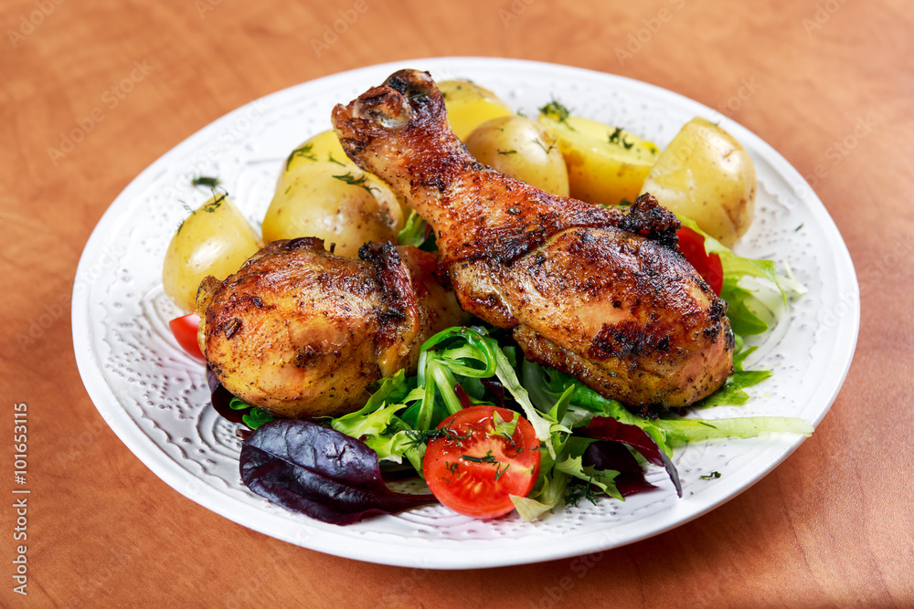 Baked chicken legs with potatoes and vegetables Baked chicken legs with potatoes and vegetables