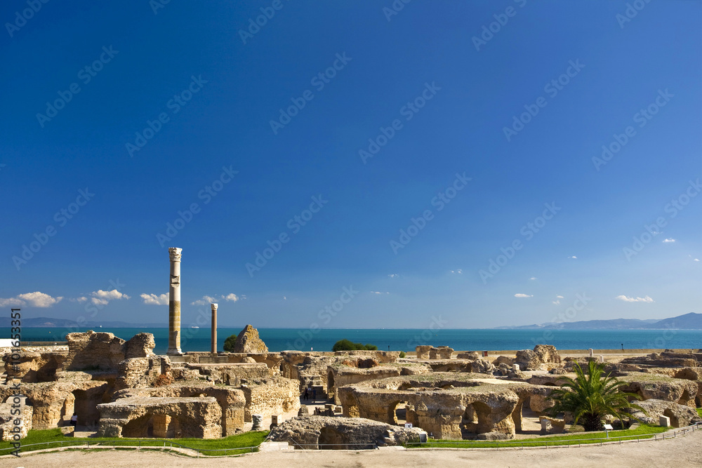 Tunisia. Ancient Carthage. General view of Antonine Baths - ruined caldarium (the hottest room) and steamroom on first plan, large column from frigidarium on left