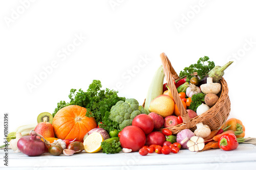 Organic vegetables and fruits in wicker basket.