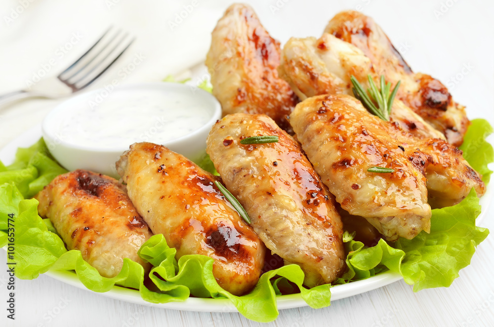 Grilled chicken wings on lettuce leaves Grilled chicken wings on lettuce leaves