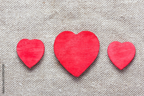 Red heart shape made with wood on linen fabric. Valentine background.