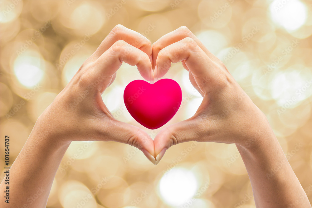 Obraz premium Pink Heart in hands on nature background