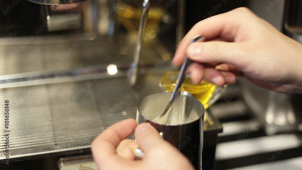 Barista steaming milk for a latte or cappuccino