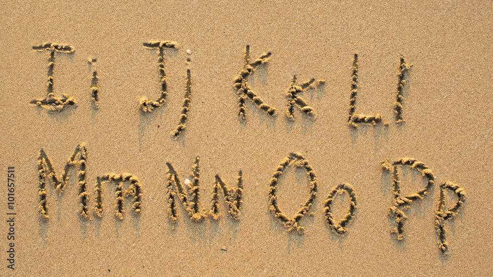 Fototapeta premium Letters of the alphabet written on sandy beach (from I to P)