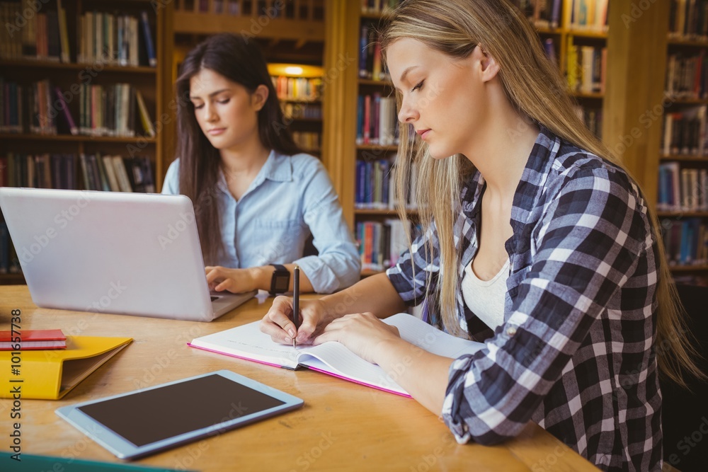 Serious student working at library 