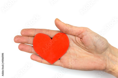Female hand showing red paper heart as symbol of love