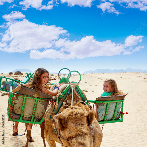 Girls riding Camel in Canary Islands photo