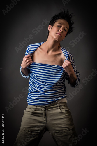 Androgynous character in a striped vest on a gray background