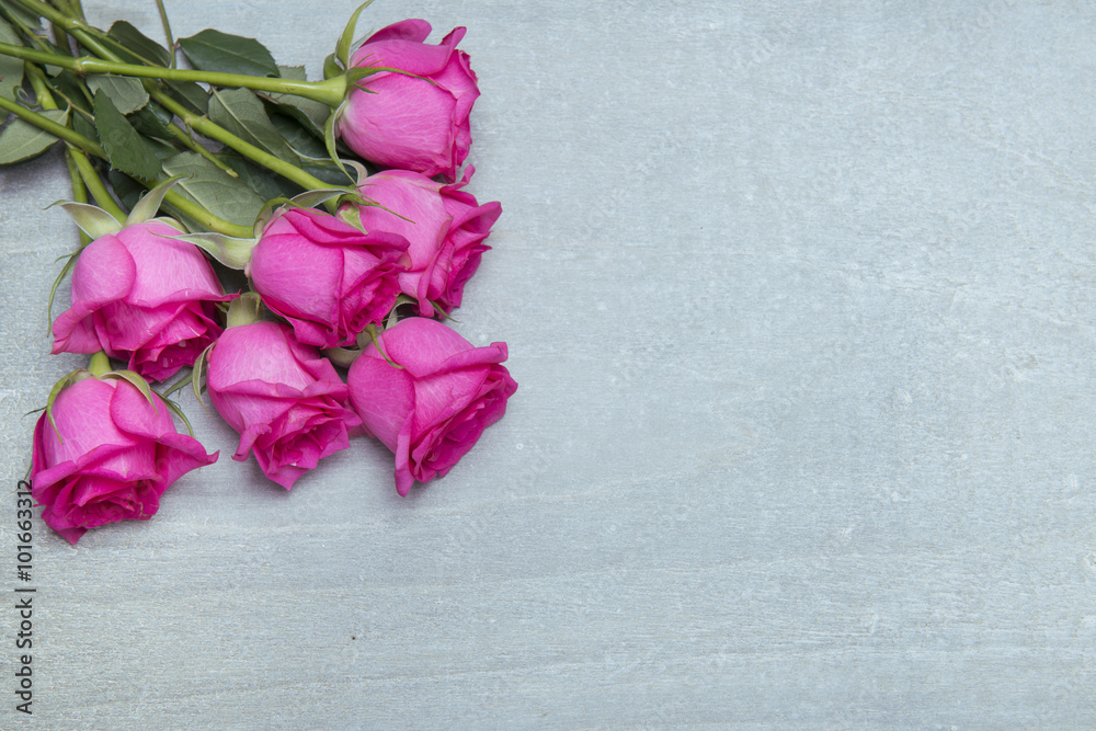 beautiful fresh roses on wooden background